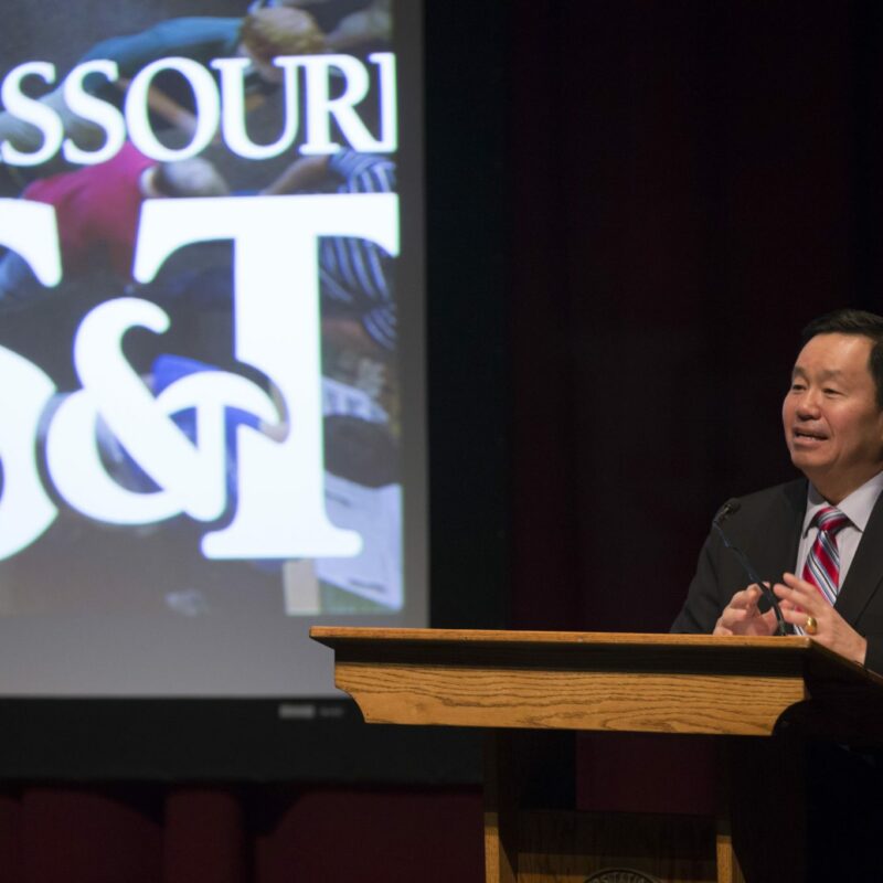 Mun Choi speaking on stage