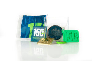 Collection of 150th anniverary items, including coin, other commemorative items