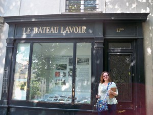 Courtney standing in front of Le Bateau-Lavoir where Modigliani and Picasso once lived and worked in an artist commune.