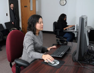 Dr. Hong Sheng, foreground, reviews eye-tracking heat maps in the Laboratory for Information Technology Evaluation at Missouri S&T. In the background are business and information technology student Sneha Pochinapeddi (seated) and Dr. Nick Lockwood. Sheng and Lockwood are assistant professors of business and information technology at Missouri S&T.