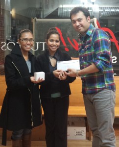 Cagatay Atmaca, a graduate student in geology and geophysics, right, presents money to Jennifer Sta Ana-Sims of Phelps County Bank (center) and Phel Eckert, a senior recreation/athletics specialist at S&T.