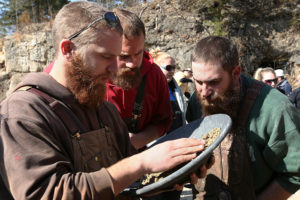 Brent Fremont (left) sifts through the gold pan as his teammates Mike Allen (center) and Matt Coy help him search as they compete on Saturday April 5. Photos by Sam O'Keefe.