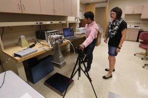 Ali Foudazi adjusts an infrared thermograph as the horn microwave heats up a section of concrete to test for flaws. Kristen Donnell, right, has been studying active microwave thermography for about two years.