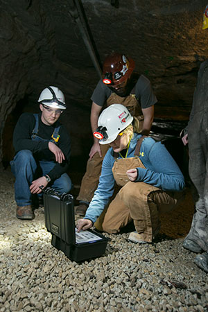 Missouri S&T students use a rotating vane anemometer, provided by Doe Run, in the Missouri S&T Experimental Mine. Shown left to right are: Benjamin Rice, Holden Henry and Katherine Burke. Photo by Sam O'Keefe