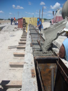 Workers at Coreslab Structures in Marshall, Mo., pour a beam during one of Dr. Dimitri Feys tests.