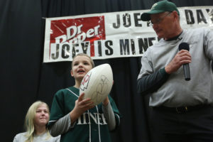 Joey holding the football signed by Kansas City Chiefs defensive back Eric Berry.