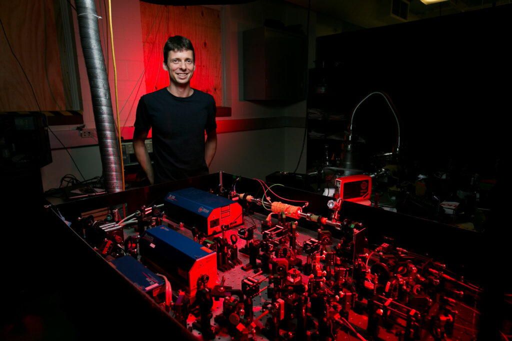 NSF CAREER Award recipient Dr. Daniel Fischer, assistant professor of physics, and his laser research setup. Sam O'Keefe/Missouri S&T