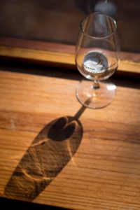 A wine glass branded with Martin Brothers Winery's logo.