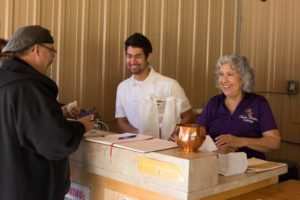 Derek (center) and Esther Martin serve a satisfied customer.