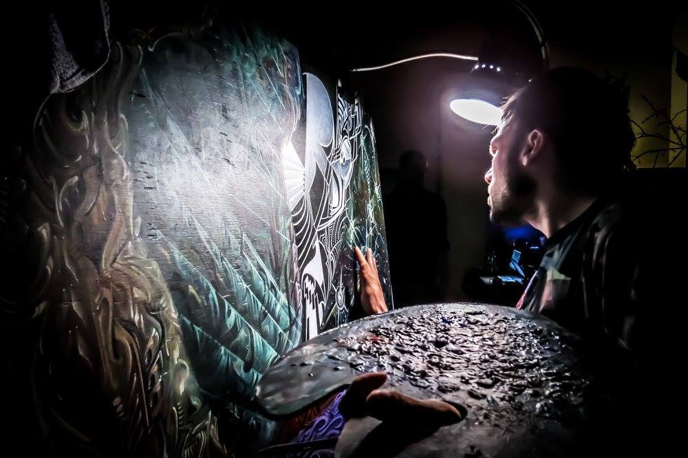 Carpenter paints one of his pieces.