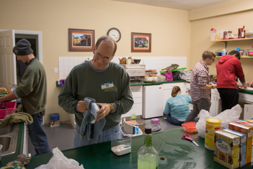 Dr. David Westenberg, associate professor and interim chair of biological sciences, helps S&T students clean and organize WomanSpace’s shared kitchen.