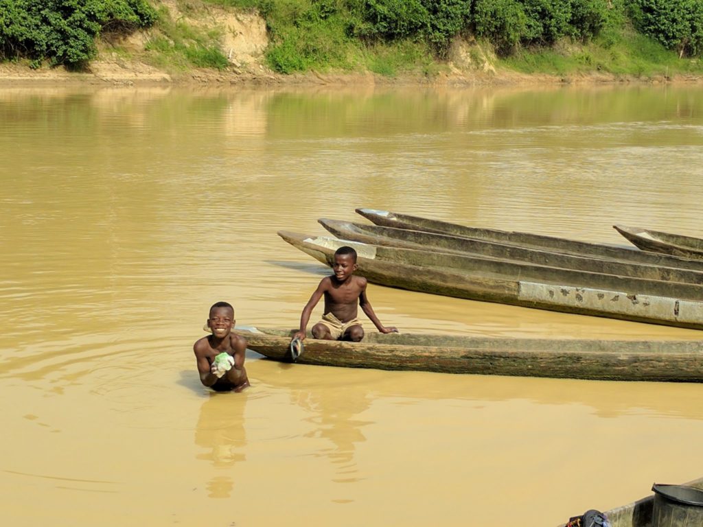 Two boys swim in the Tano River near Ghana's western border with Ivory Coast. Contamination from artisanal mining has rendered the river's water unfit for human consumption. Photo by Kenneth Bansah.