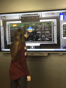 Katie Frogge tests the digital touch screen in the T-X Classroom at Boeing's St. Louis facility. Boeing photo.