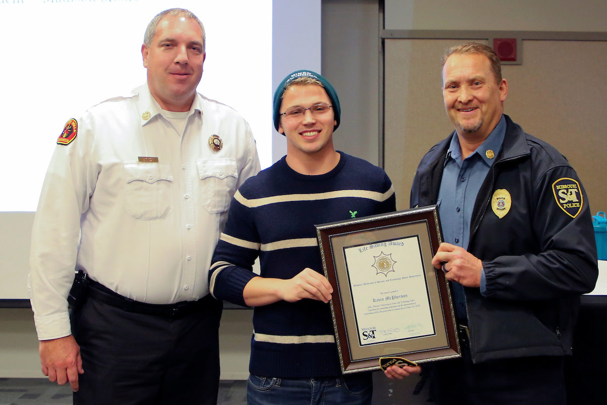 Missouri S&T electrical engineering senior Kevin McPherson (center) was honored by Rolla Fire Chief Ron Smith (left) and S&T Police Chief Doug Roberts for saving a fellow student from drowning.