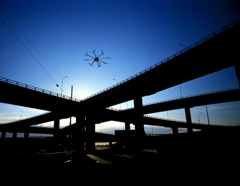 Photo of unmanned aerial vehicle above bridge.