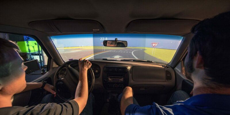Students use a driving simulator to test roadway design before construction