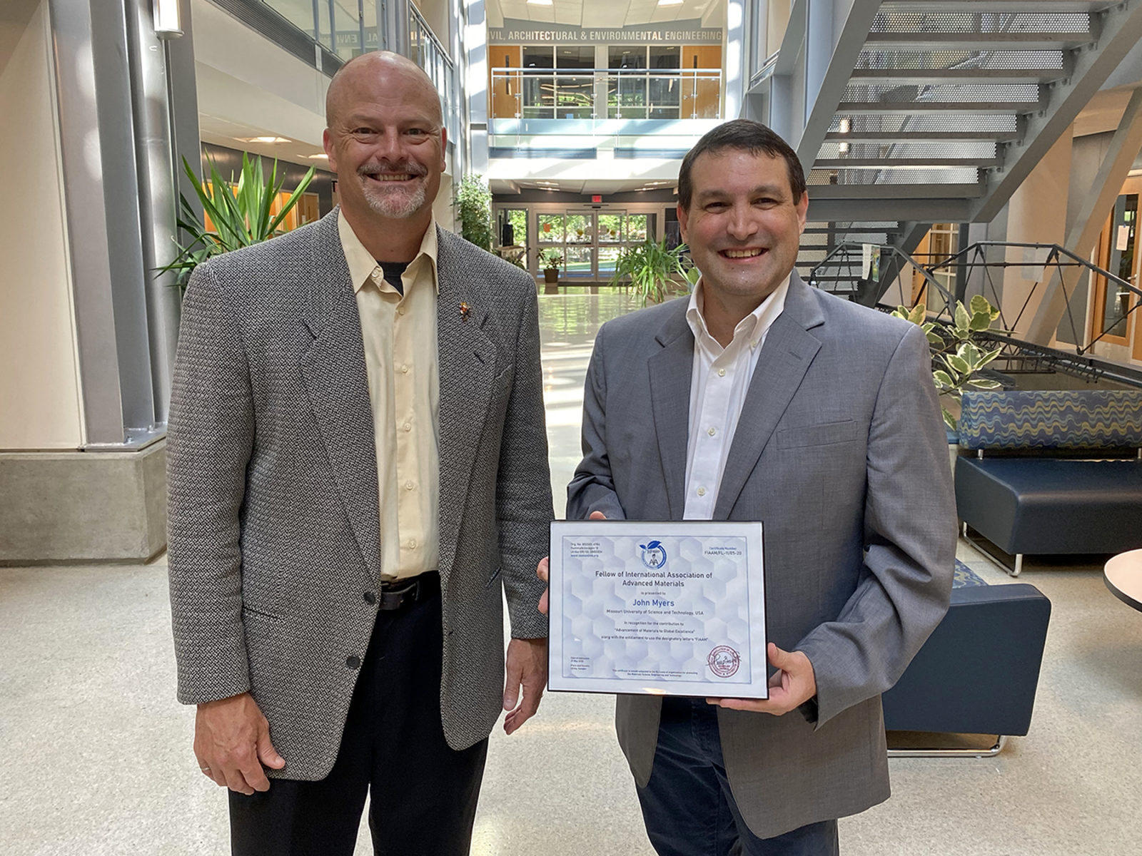 Drs. Joel Burken and John Myers in Butler-Carlton Hall with Myers' IAAM fellow award certificate