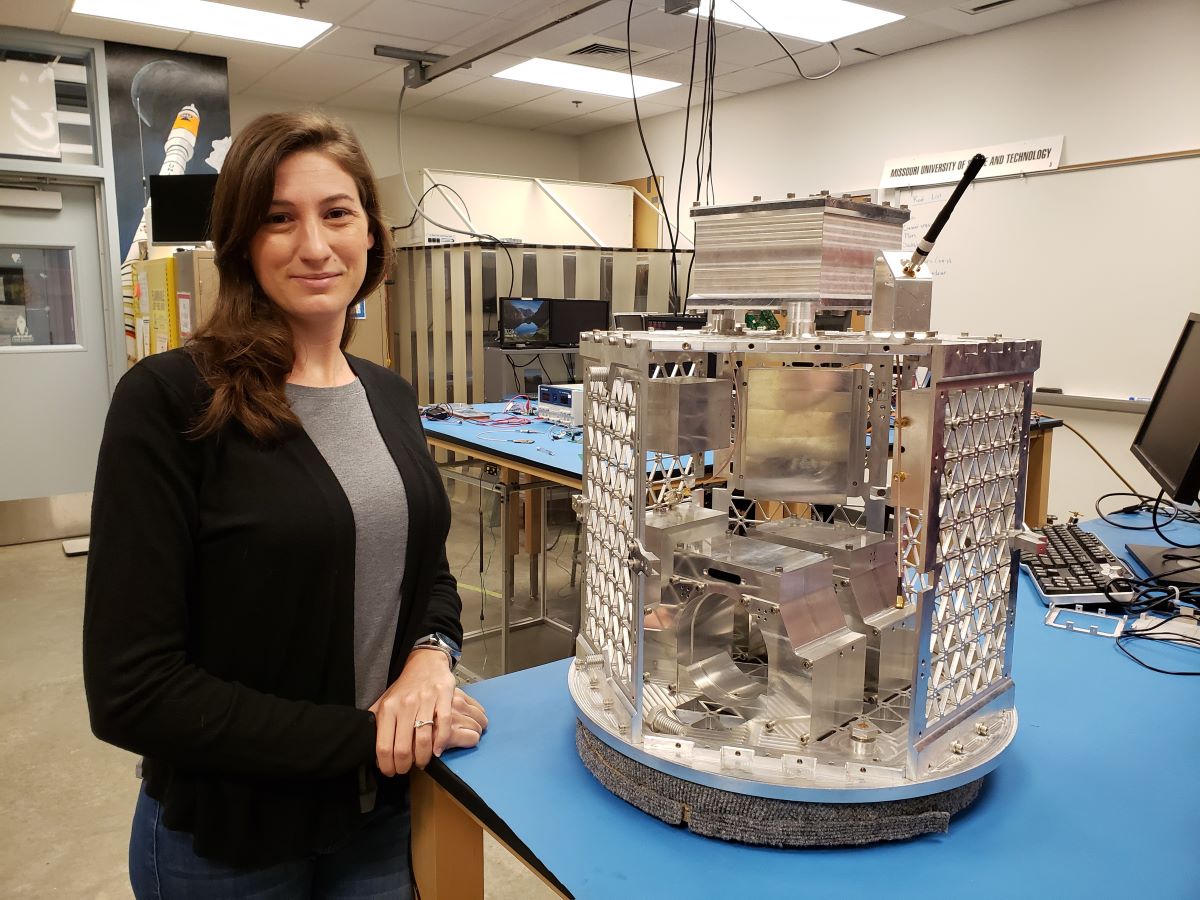 Jill Davis, Ph.D. student, in lab with small satellite