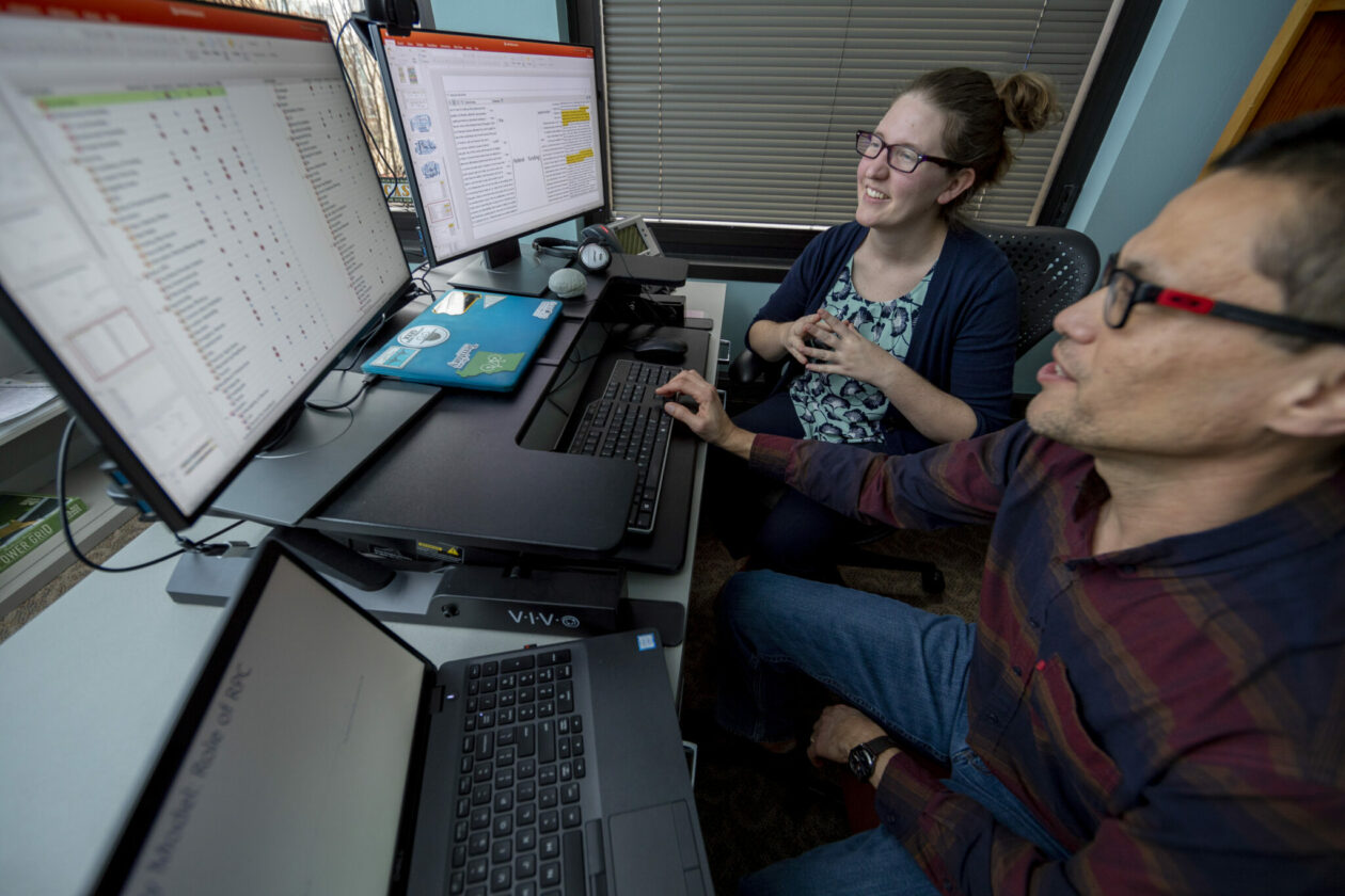 Photo of Canfield and her student conduct research in rural broadband access.
