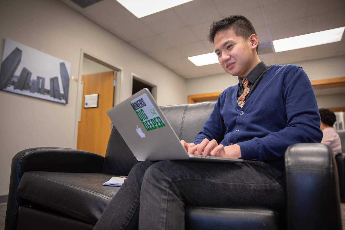 Gladwin Bryan Labrague with a laptop computer