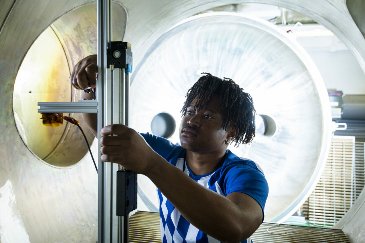 Photo of student in plasma vacuum chamber