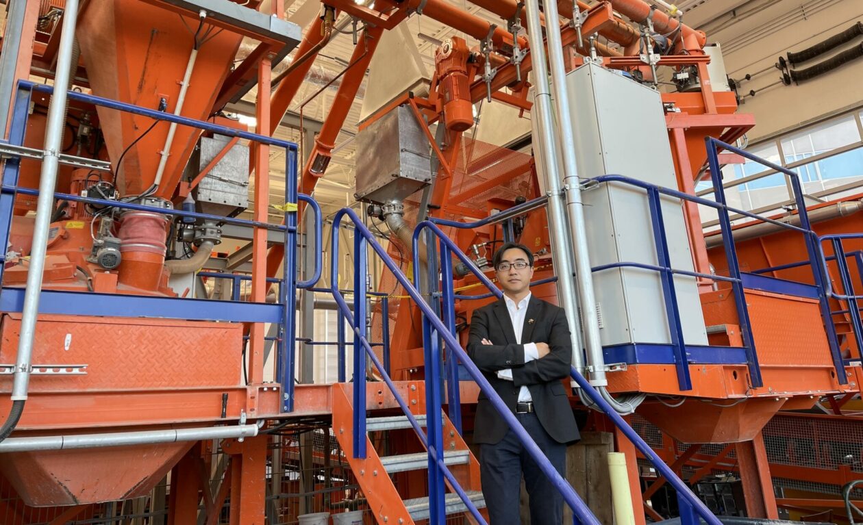 Dr. Hongyan Ma with S&T's semi-industrial scale concrete batching plant.
