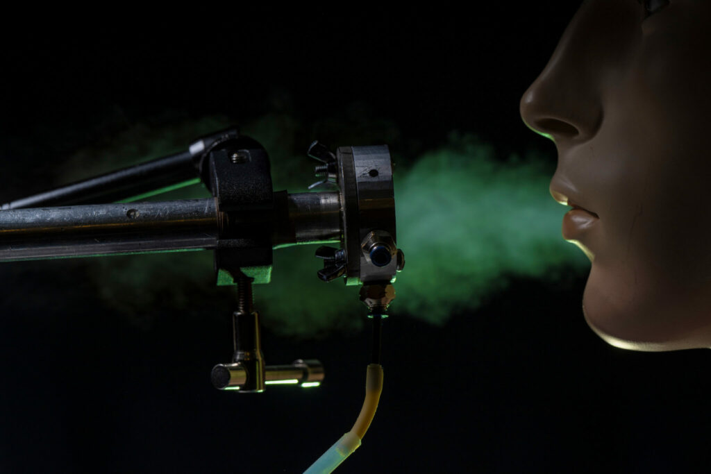 Breathing apparatus with breath illustrated with green fog