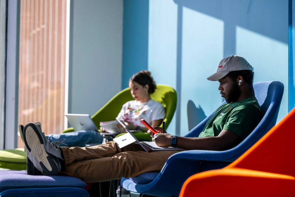 Two students in lounge chairs in Innovation Lab