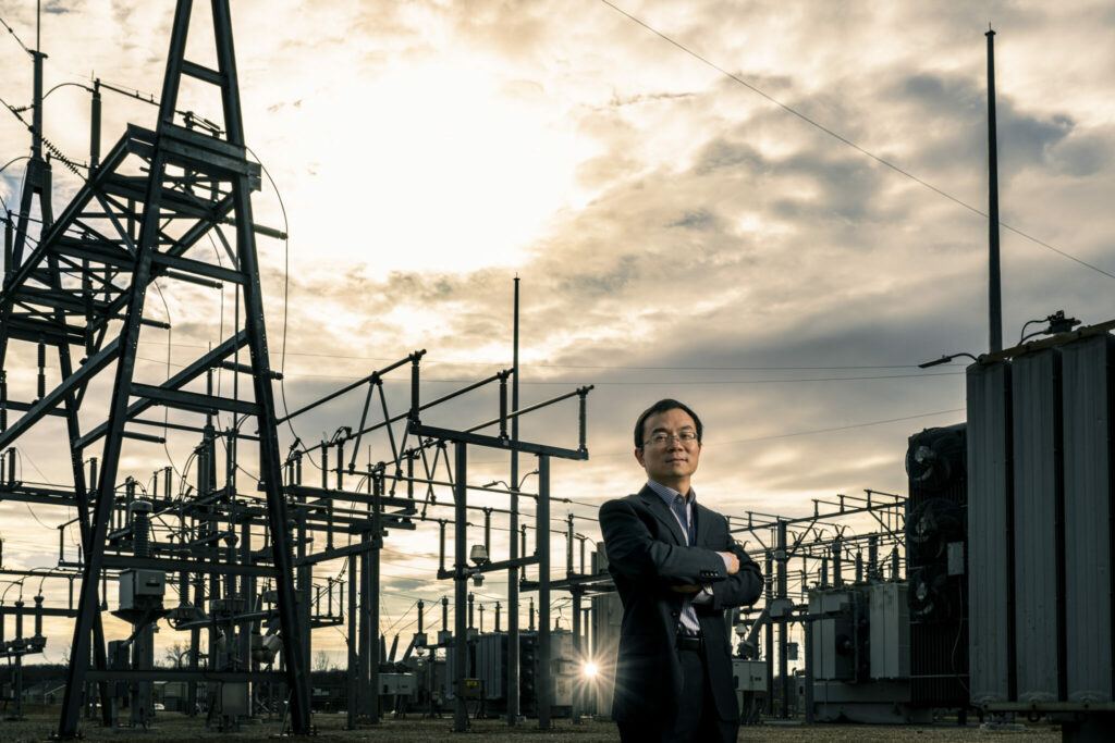 Dr. Rui Bo stands at a Rolla Municipal Utilities electrical substation. Michael Pierce/Missouri S&T.