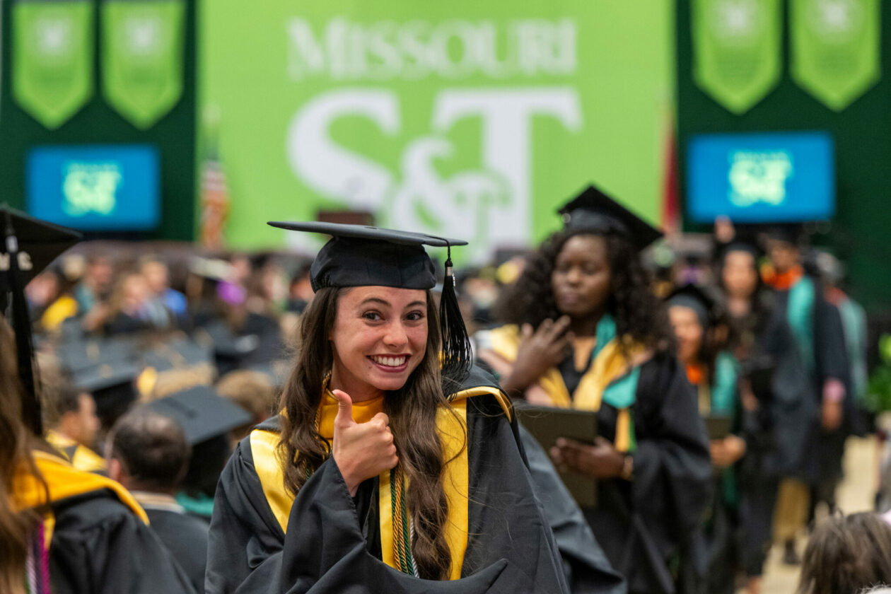 Graduate gives "thumbs up" as departing during recessional of S&T commencement ceremony on May 11, 2024.