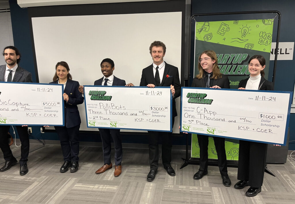 Startup Challenge student winners with big checks
