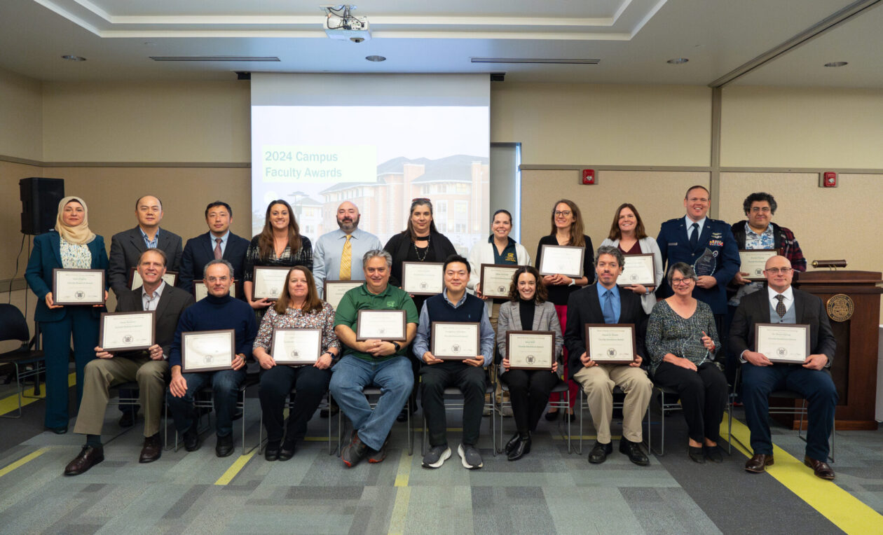 Group photo of awardees holding plaques