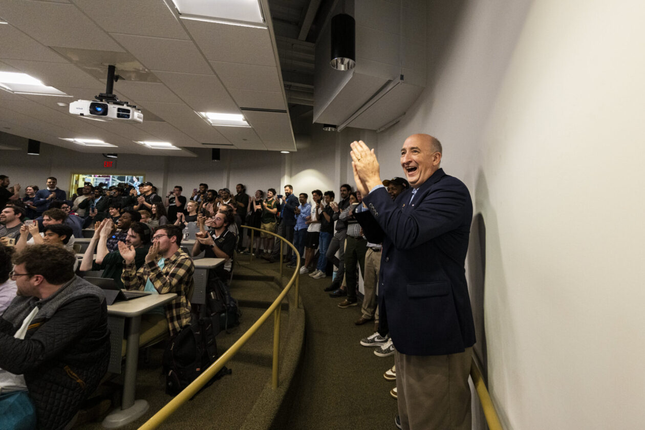 Dr. David Bayless, front right, claps after the successful launch of a student-designed satellite into space. Photo by Michael Pierce/Missouri S&T.