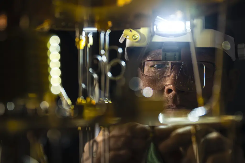 Man wearing goggles and headlight in physics lab