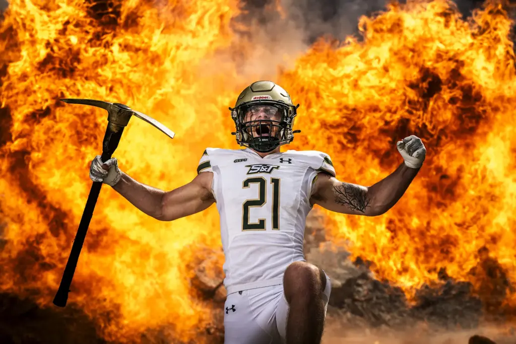 Football player with pick axe and fireball