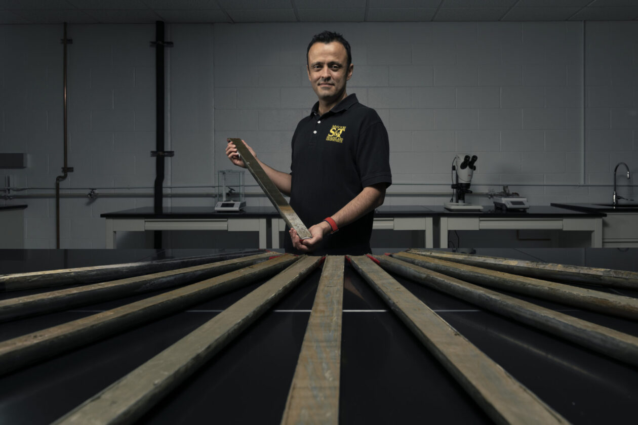 Dr. Jonathan Obrist-Farner stands with sediment core samples used for his research in a Missouri S&T lab. Photo by Michael Pierce/Missouri S&T.  