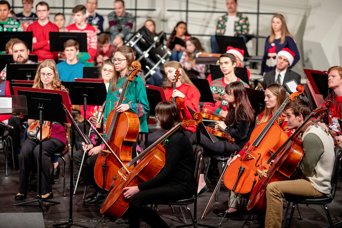 Student musicians perform on the Leach Theatre stage during a holiday concert.
