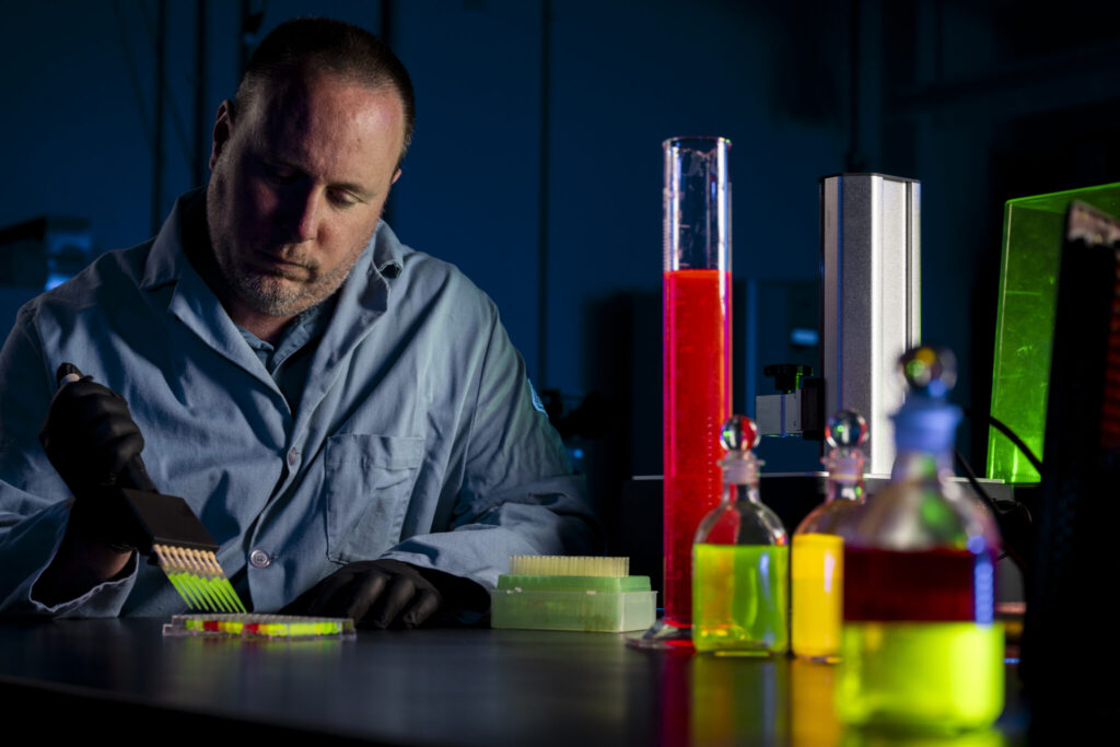 Dr. Anthony Convertine prepares a liquid resin for 3D printing biomaterials used for tissue engineering. Photo by Michael Pierce/Missouri S&T.