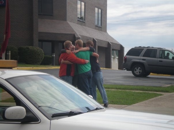 The Show-Me Solar team shares a group hug after seeing the house off